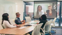 Business people having a virtual meeting in a boardroom