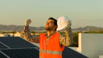 Happy Solar Professional Holds Fists Up