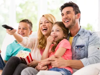 Family watching TV at home