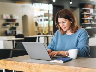 Woman using laptop in a salon - security confidence