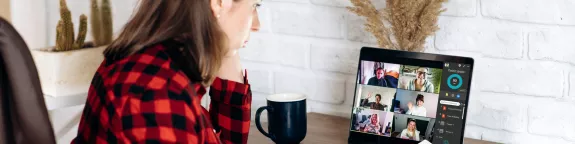 Woman attending an online meeting from home