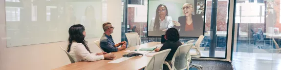 Business people having a virtual meeting in a boardroom