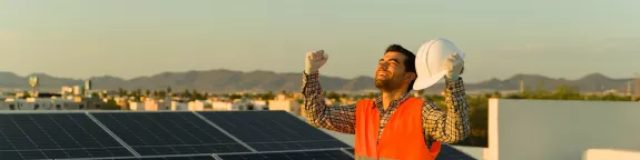 Happy Solar Professional Holds Fists Up