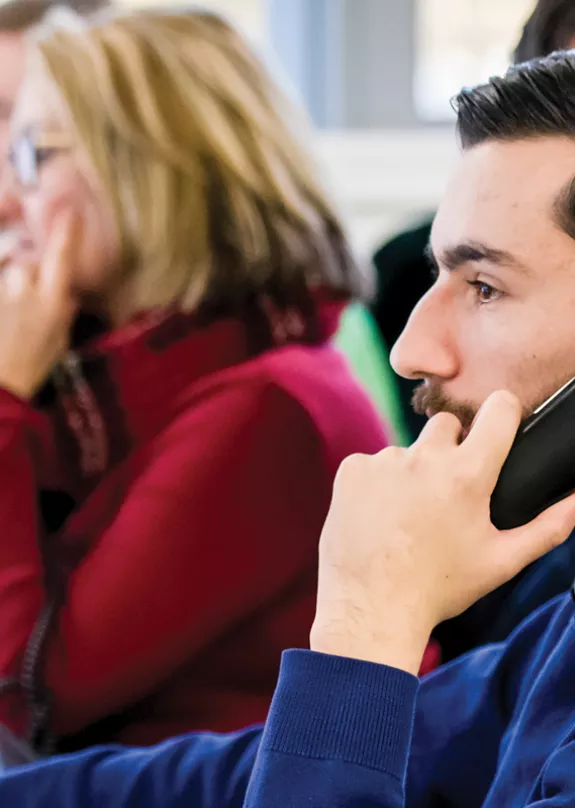 People using phones at their desks